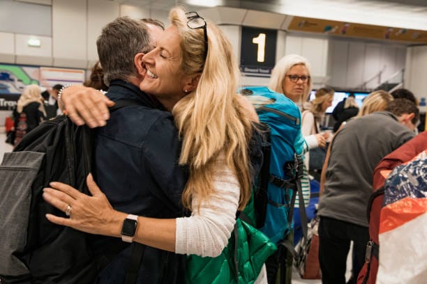 people hugging at airport